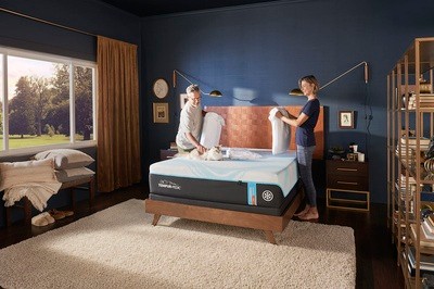 A couple making the bed