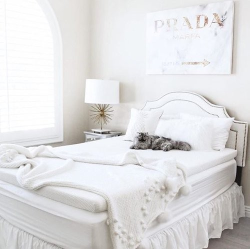 A room with white furniture, decor and a mattress that has a tempur-topper supreme
