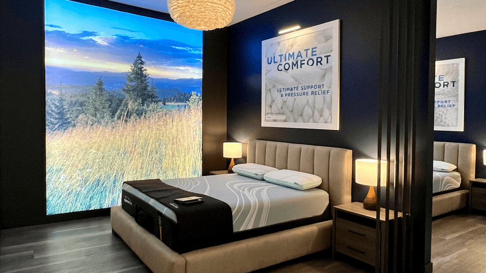 A Tempur-Pedic Retail Showroom Sleep Pod with a Scenic Background showing Trees and Long Grass