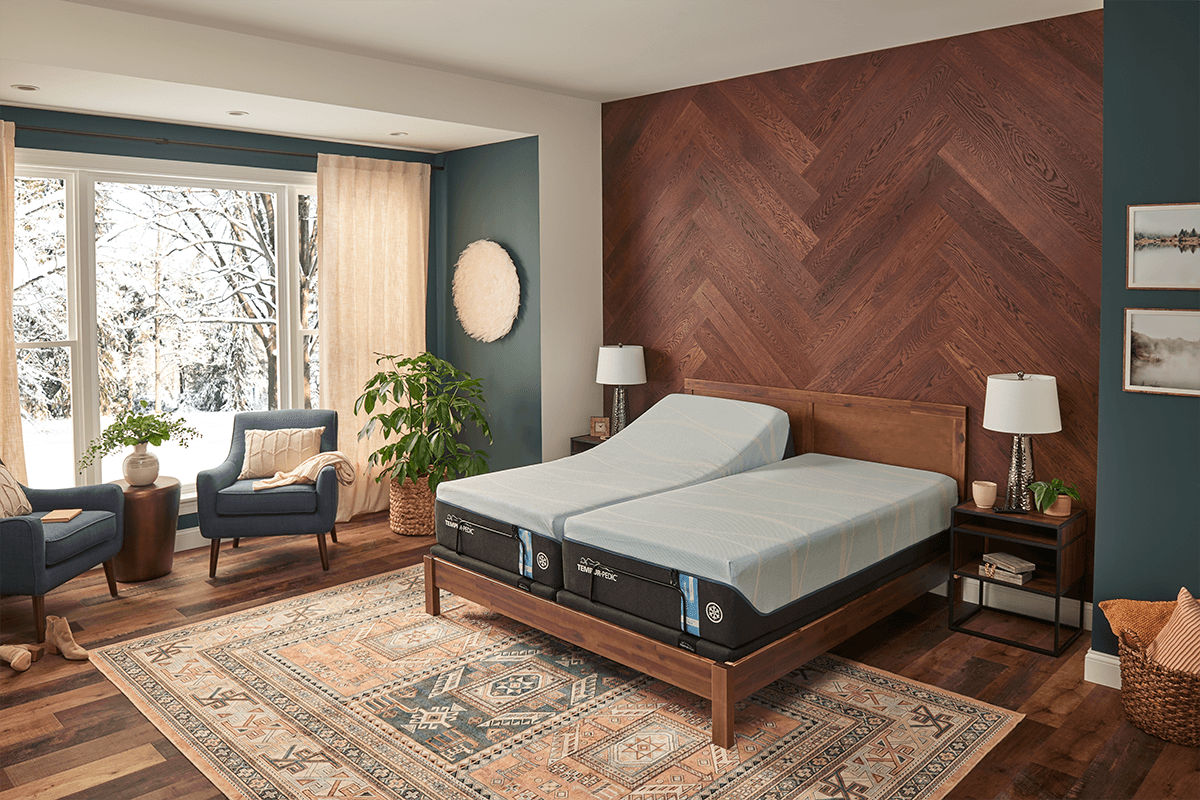 A styled room with a split king bed and adjustable base