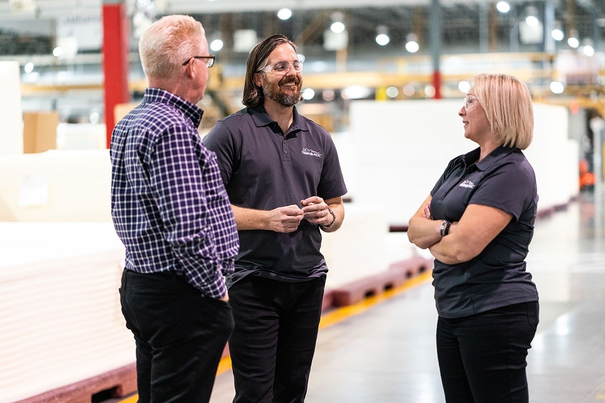 Three engineers talking in TempurPedic Factory