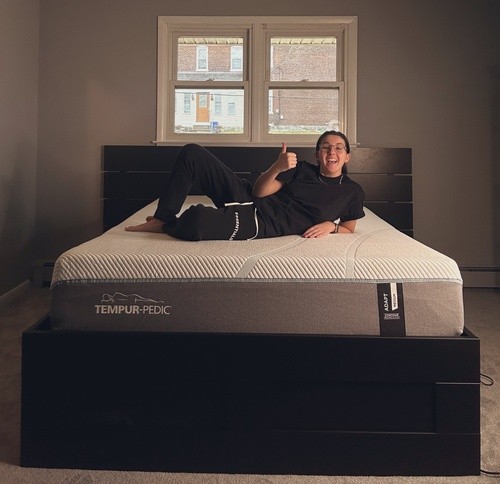 Tempur Pedic customer laying on bed