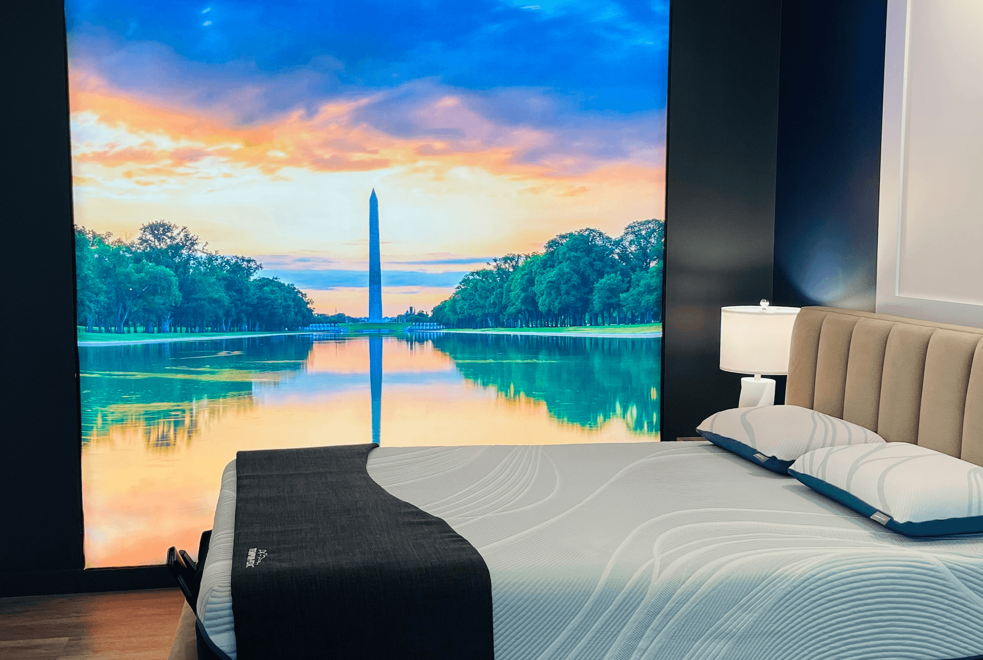A showroom bed with an image of the Washington Monument in the background