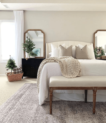 Home On Hartman instagram photo of bed with tan bedding in room decorated for christmas.png