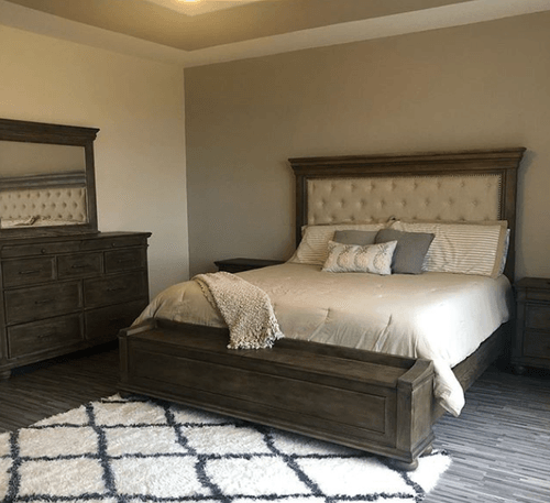 Mattress with wooden bed frame and wooden dresser.png