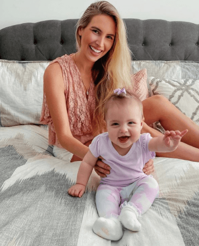 Melissa Metrano Photo of woman holding baby on mattress