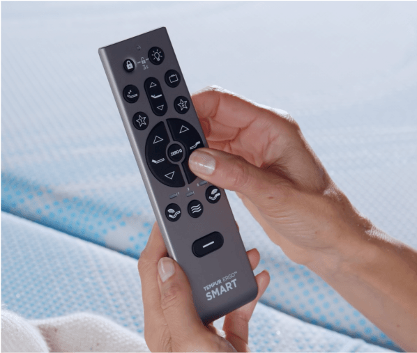 A person holding a base remote