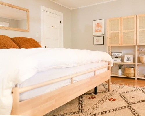 Photo of mattress on wooden bed frame with white bedding.jpg