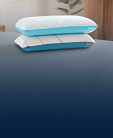 A stack of Breeze and Adapt pillows on a mattress