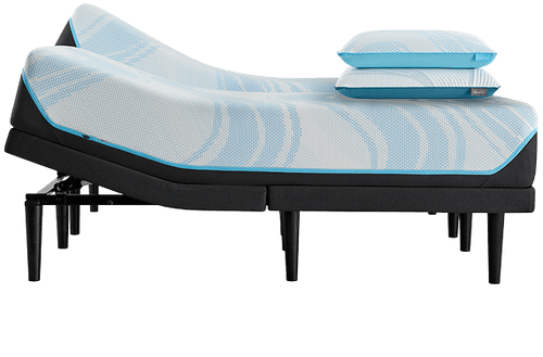 a pair Breeze mattress on a power base with the head slightly lifted and two pillows stacked at the foot