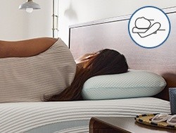 Woman laying on her back with TempurPedic Comfort Pillow