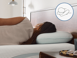 Woman laying on her back with TempurPedic Comfort Pillow