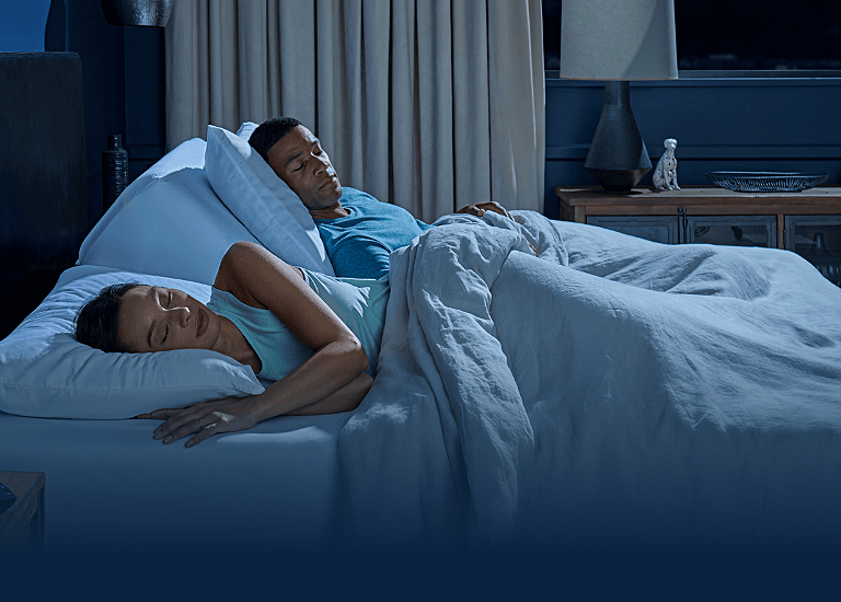 A couple sleeping on a bed
