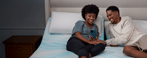 Couple Smiling at Phone on LuxeBreeze Split Head Mattress