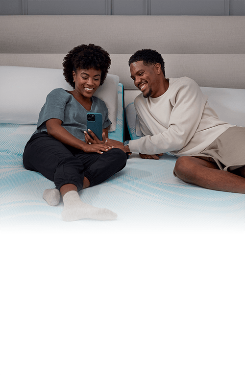 Couple Smiling at Phone on Split Head King mattress