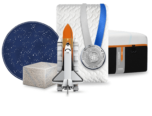 A Tempur-Pedic mattress, pillow, block of TEMPUR material and a spaceship arranged together