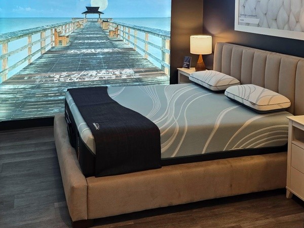 A Tempur-Pedic Retail Showroom Sleep Pod with an Image of a Pier in the Background