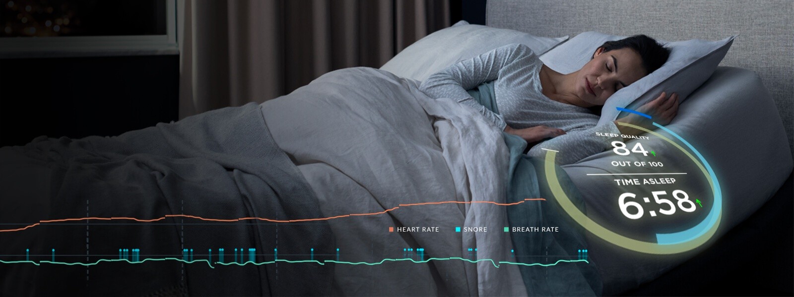 Woman sleeping with her Tempur-Ergo® Smart Base monitoring her snoring, heart rate, and breath rate