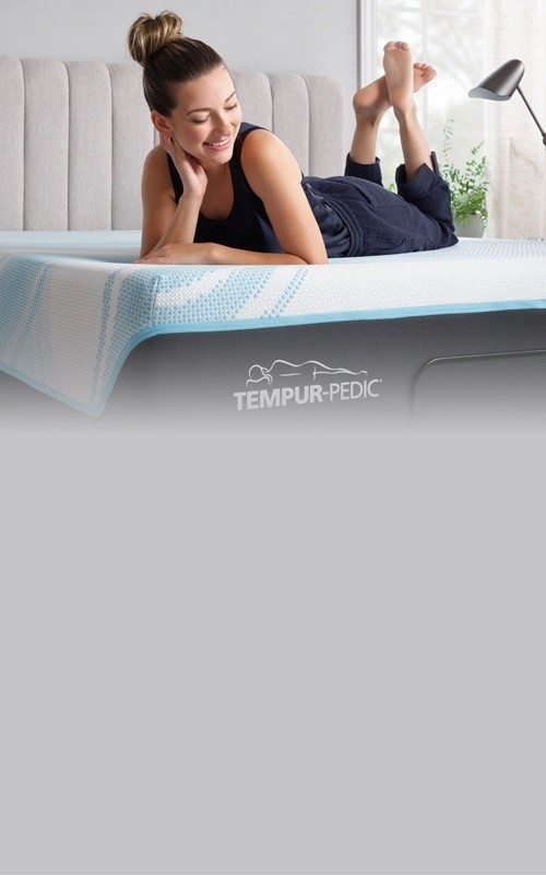 Woman lounging on her Tempur mattress