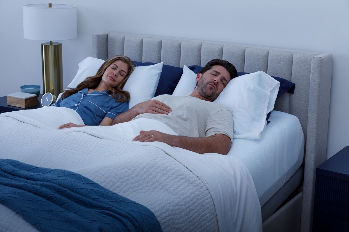 Couple sleeping in bed in a dark room