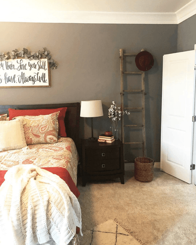 Half of styled bed in bedroom