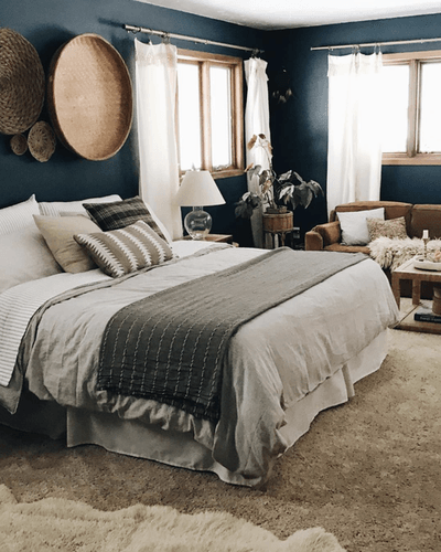Styled bed in decorated bedroom