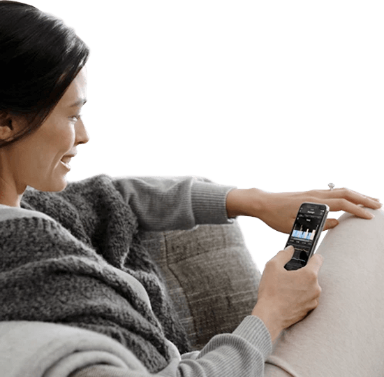 A woman smiling while using the Sleeptracker app