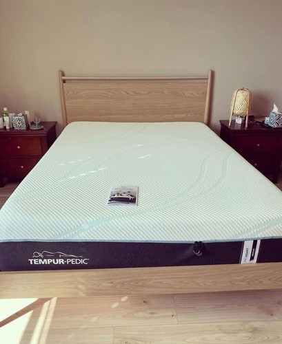 Tempur-Pedic ProAdapt mattress on a wooden bed frame with a nightstand on each side