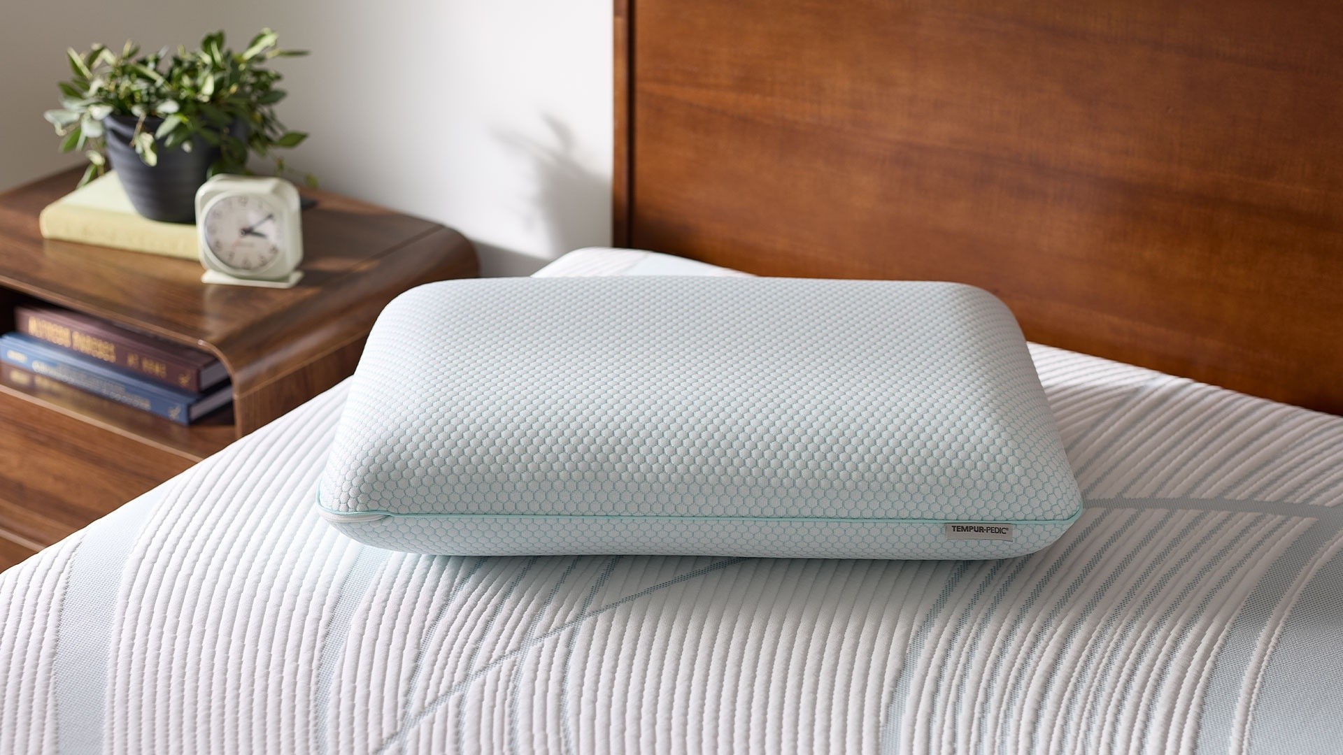 Tempur-Pedic Comfort Pillow on an undressed bed