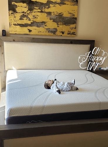 picture of a baby laying on a mattress